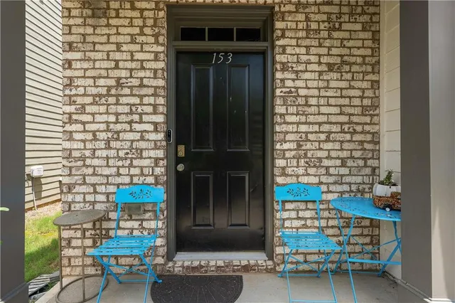 a view of a door of the house with outdoor seating