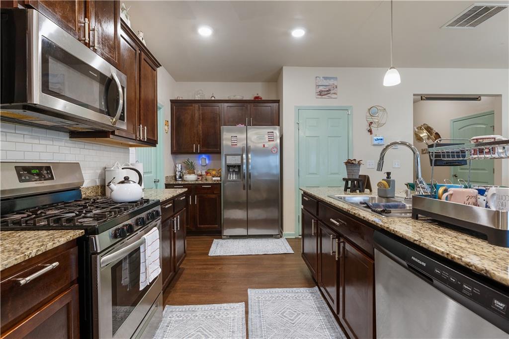 153 Centennial Ridge Drive Acworth, GA 30102 - Photo 7 of 38 a kitchen with stainless steel appliances granite countertop a stove a sink dishwasher a refrigerator and a microwave