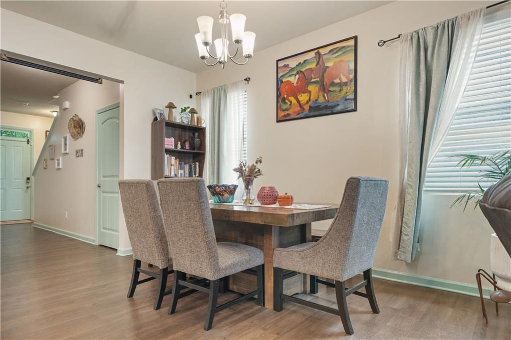 153 Centennial Ridge Drive Acworth, GA 30102 - Photo 8 of 38 a dining room with furniture a chandelier and wooden floor