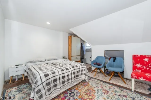 a living room with furniture and a dining table with a workspace