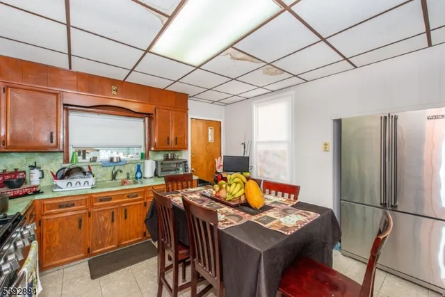 a kitchen with stainless steel appliances wooden floor and a window