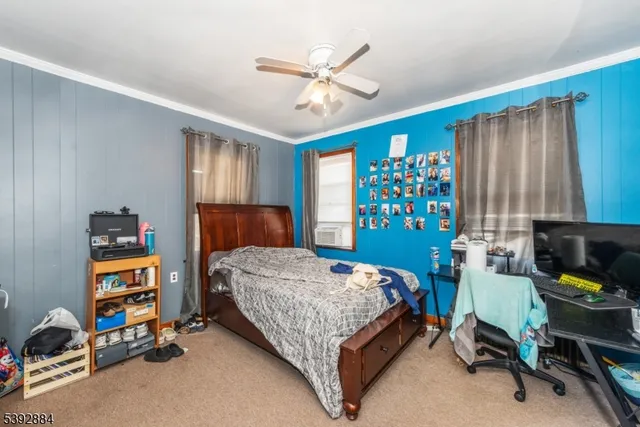 a bedroom with a bed and large windows