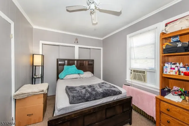 a bathroom with a toilet a sink a mirror a window and vanity