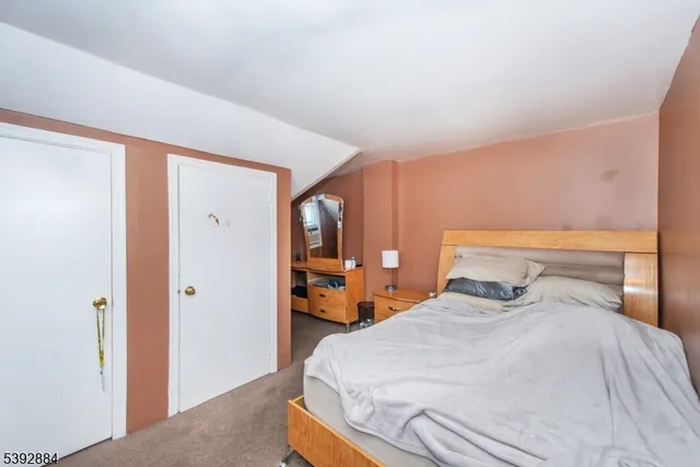 a bedroom with bed and window