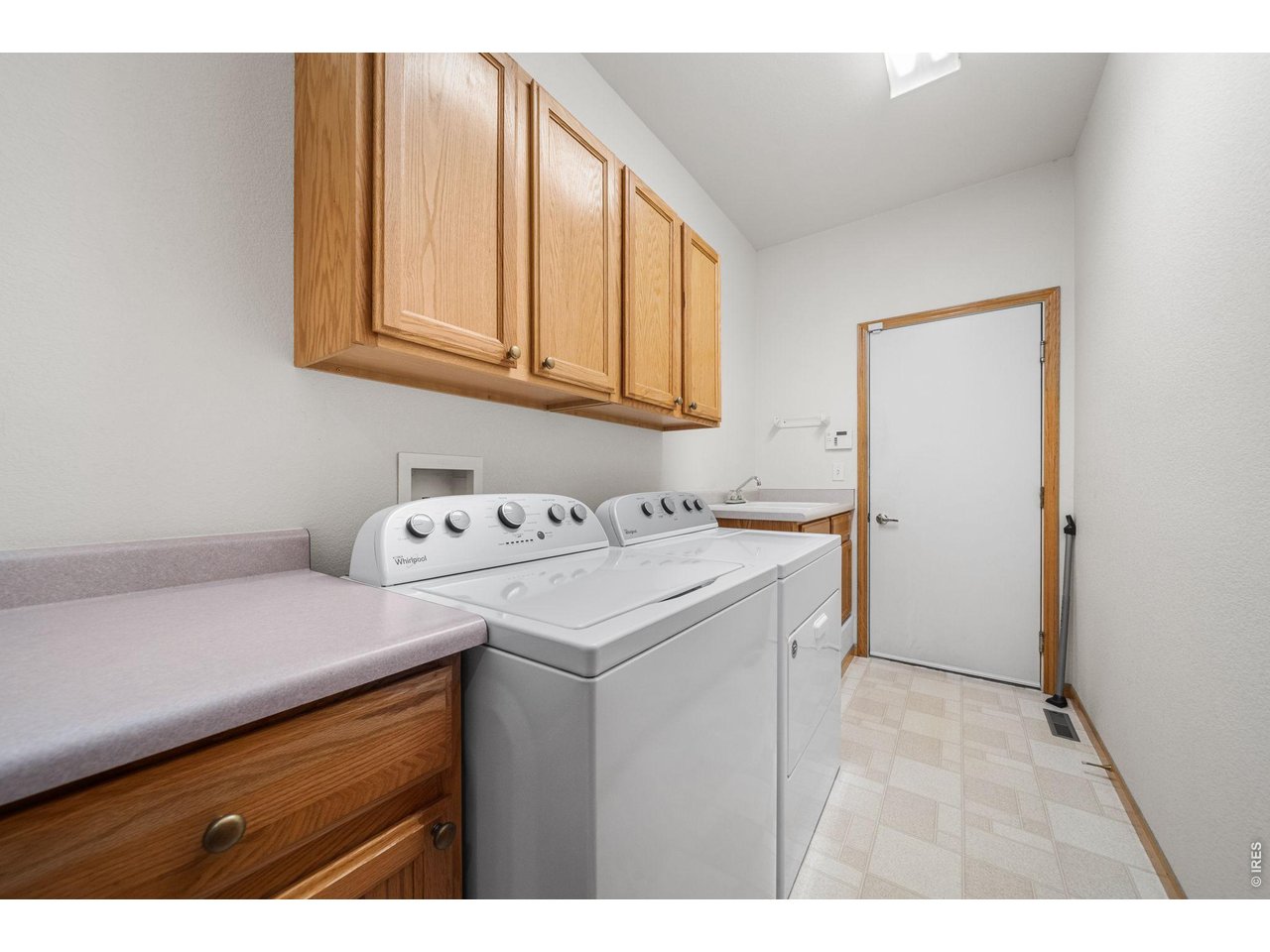 4014 Carrick Road Fort Collins, CO 80525 - Photo 24 of 41 Main floor laundry room with cabinetry