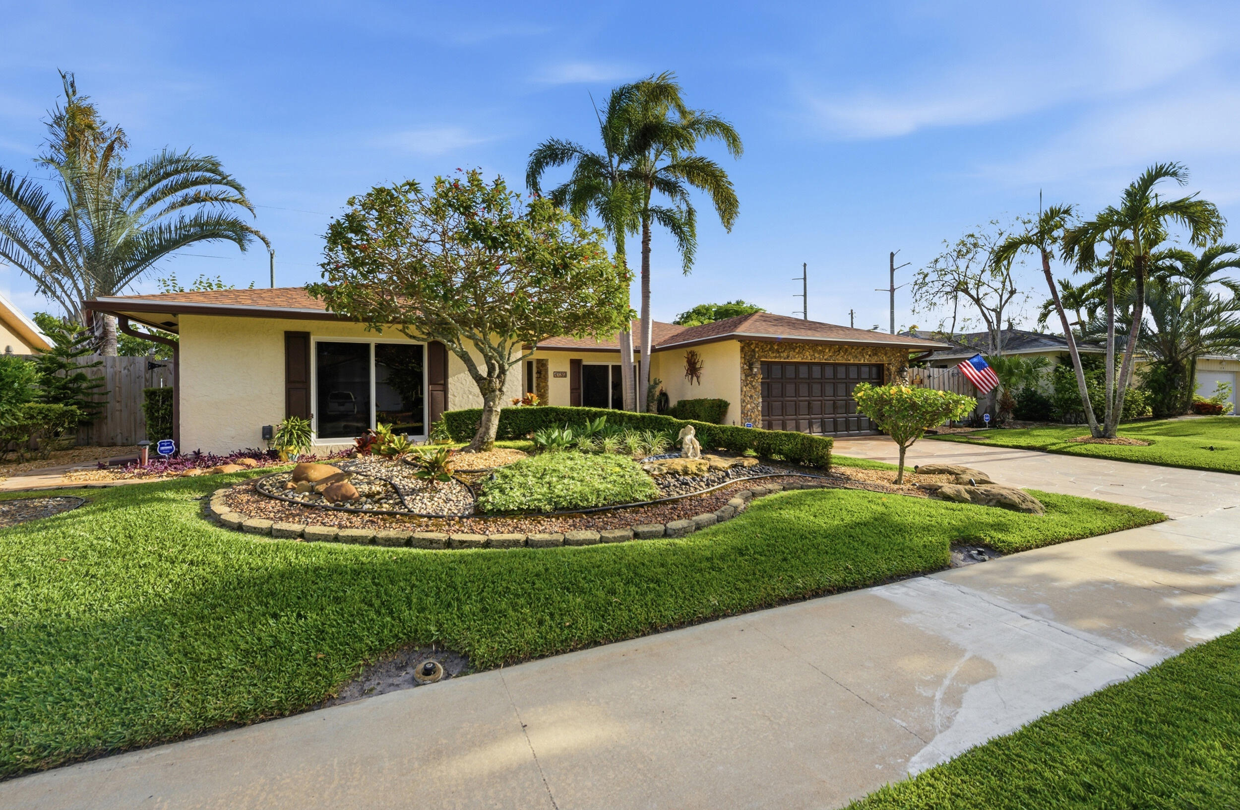 4780 Brandywine Drive Boca Raton, FL 33487 - Photo 6 of 43 a front view of a house with fountain and entertaining space