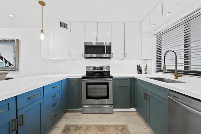 a kitchen with a sink stove and microwave