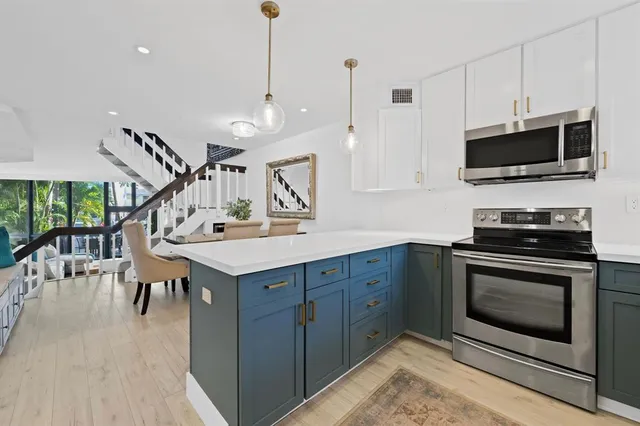 a kitchen with a stove a sink and a microwave