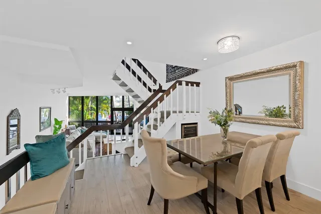 a view of a dining room with furniture a chandelier and wooden floor