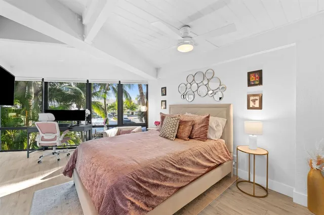 a bedroom with a large bed and a large window