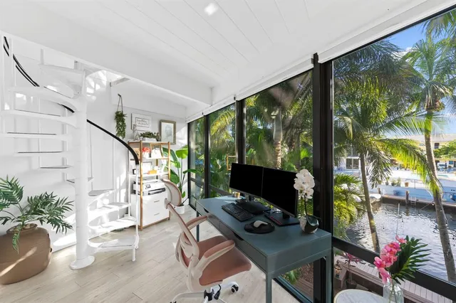 a workspace with furniture bookshelf and a window
