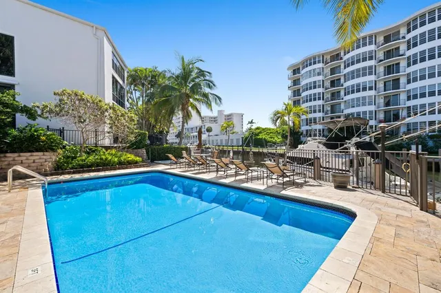 a view of a swimming pool with outdoor seating