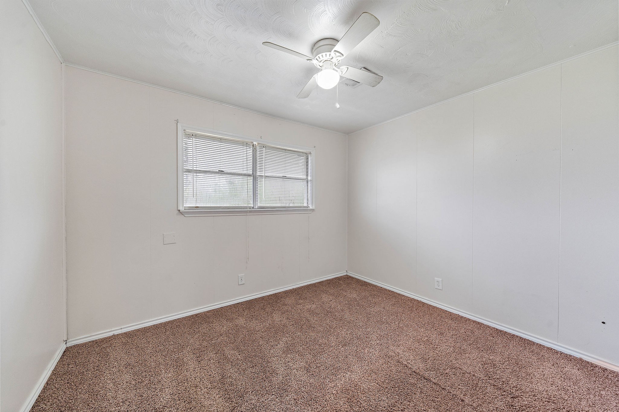3230 Virginia Street La Marque, TX 77568 - Photo 16 of 18 an empty room with a window and a fan