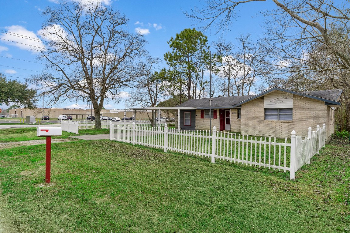3230 Virginia Street La Marque, TX 77568 - Photo 2 of 18 a view of a house with a yard and a large tree