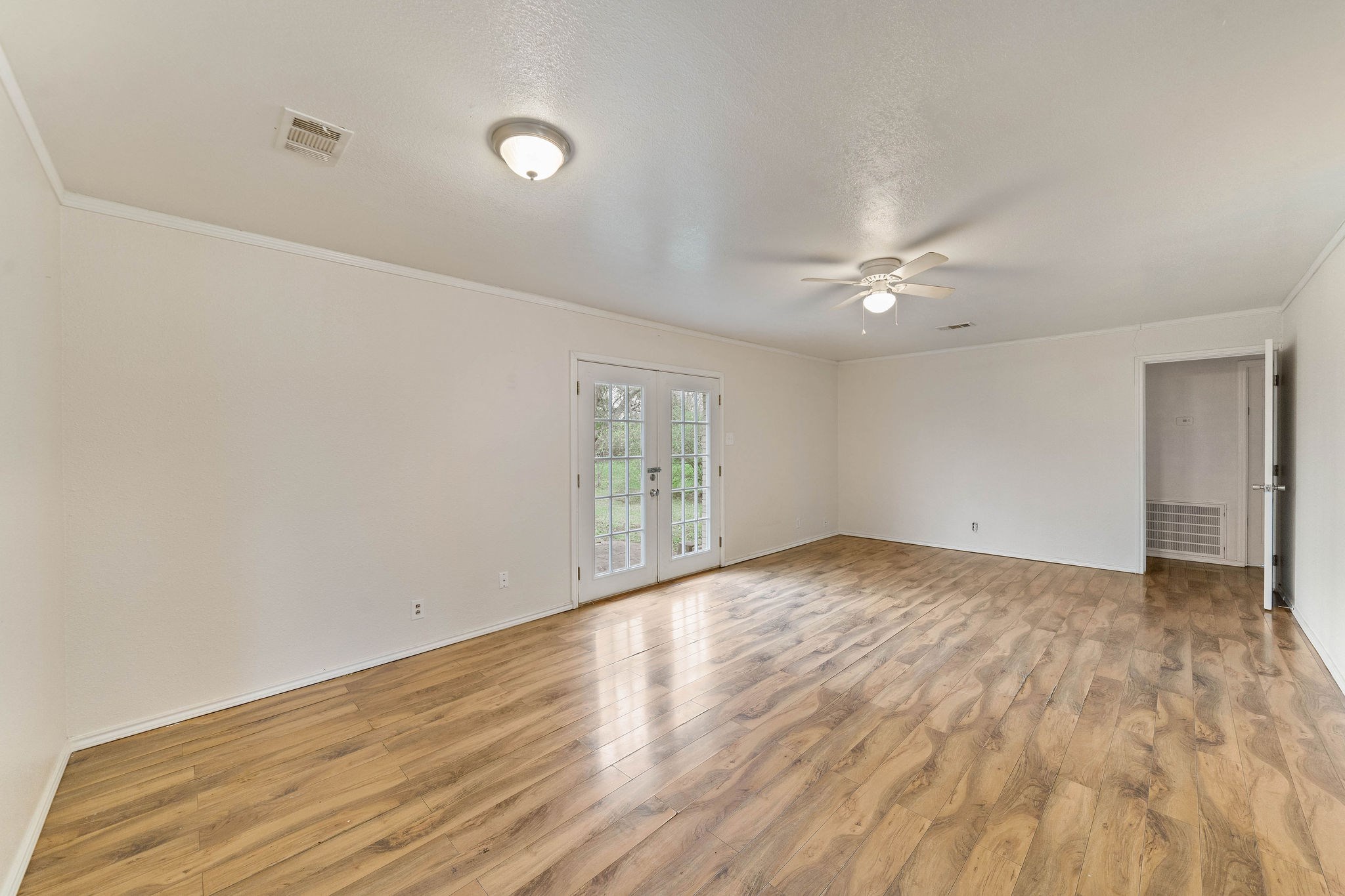 3230 Virginia Street La Marque, TX 77568 - Photo 6 of 18 a view of an empty room with wooden floor and a window