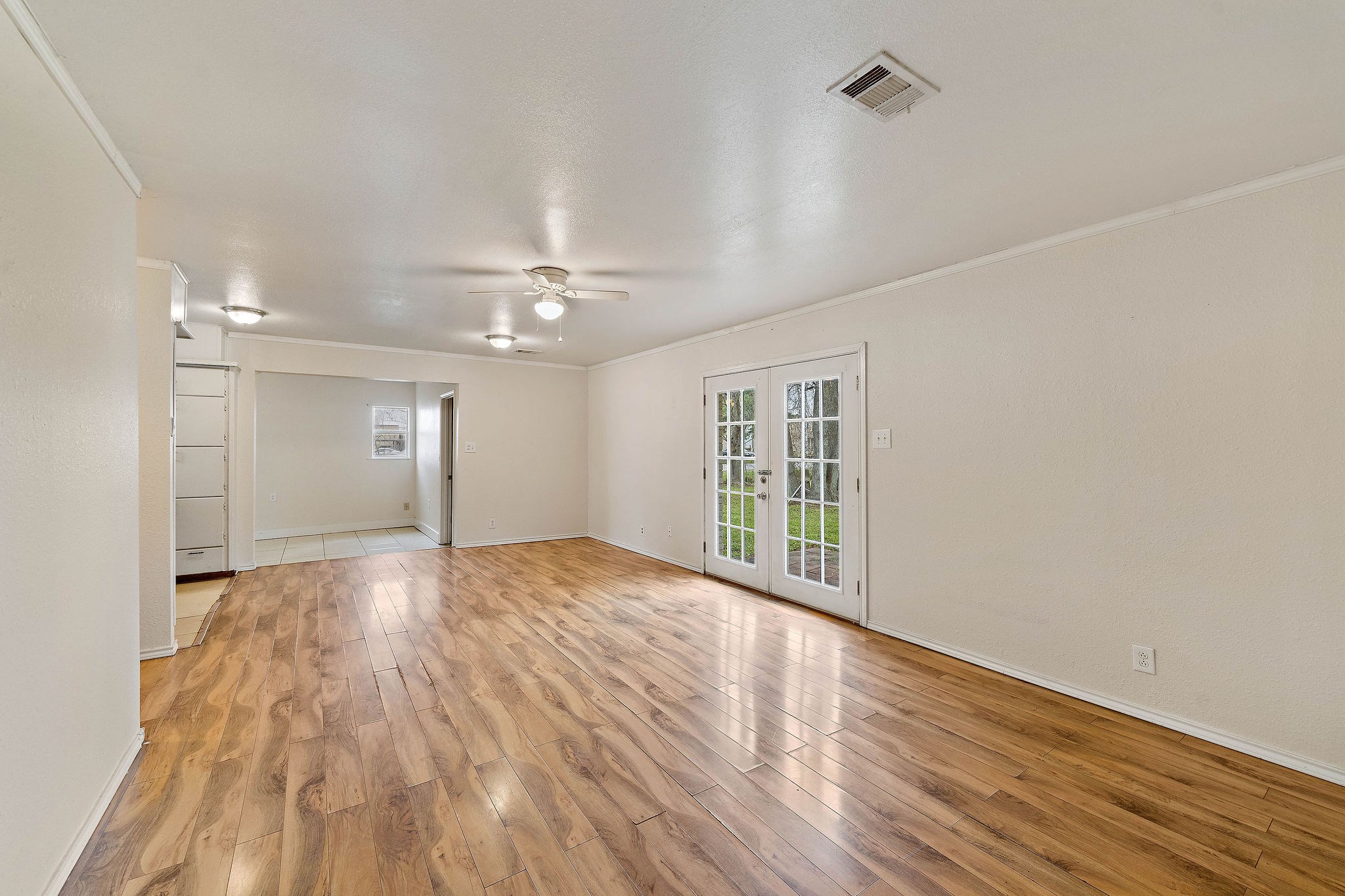 3230 Virginia Street La Marque, TX 77568 - Photo 7 of 18 a view of an empty room with wooden floor and a window