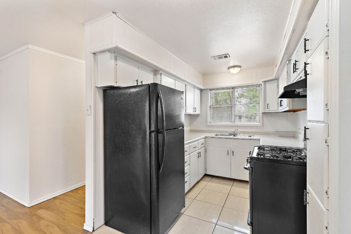3230 Virginia Street La Marque, TX 77568 - Photo 8 of 18 a kitchen with a refrigerator and a sink