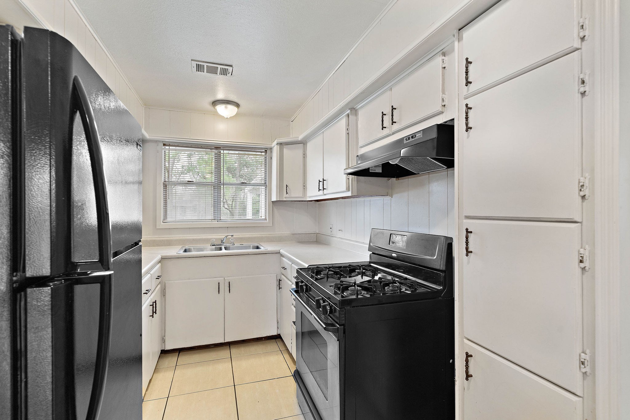 3230 Virginia Street La Marque, TX 77568 - Photo 9 of 18 a kitchen with stainless steel appliances a refrigerator sink and stove