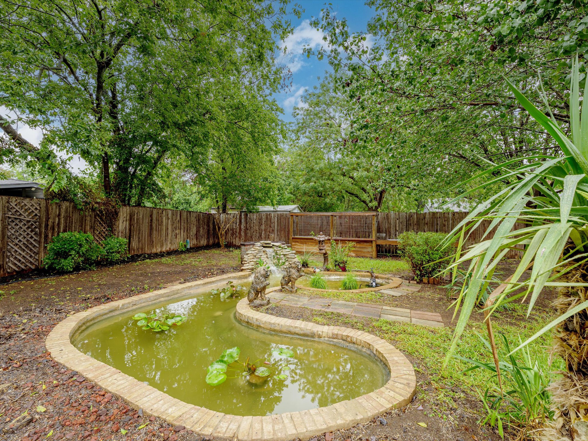 Relax around the pond and enjoy the views of the surrounding soaring shade trees.
