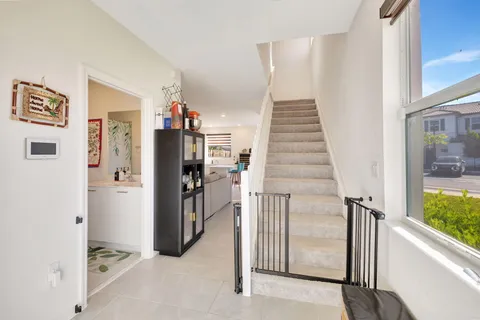 a view of a hallway with windows and entryway