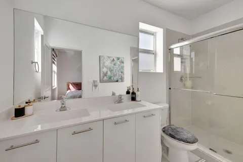 a bathroom with a sink a toilet and a mirror