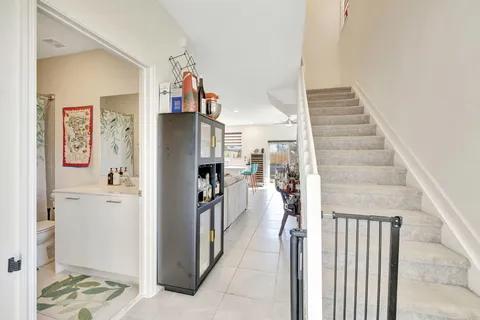 a view of a hallway with wooden floor and entryway