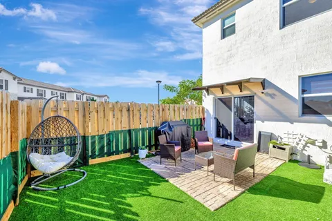 a view of a house with backyard and a patio