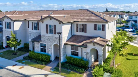 a aerial view of a house with a yard and potted plants