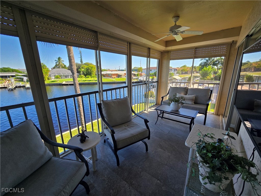 4631 Southeast 5th Avenue, Unit 207 Cape Coral, FL 33904 - Photo 13 of 19 a living room with furniture and a floor to ceiling window