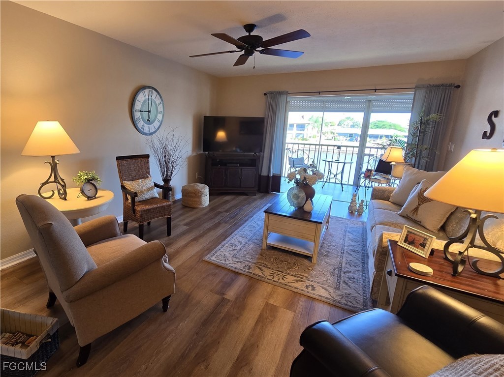 4631 Southeast 5th Avenue, Unit 207 Cape Coral, FL 33904 - Photo 3 of 19 a living room with furniture a fireplace and a large window