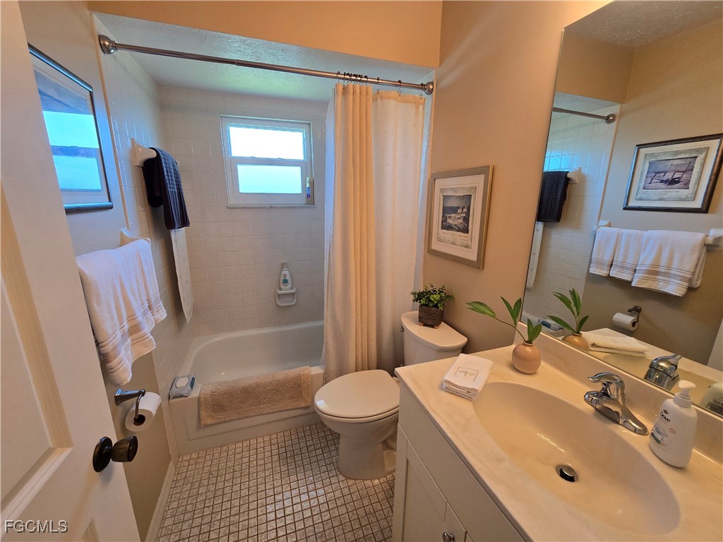 4631 Southeast 5th Avenue, Unit 207 Cape Coral, FL 33904 - Photo 10 of 19 a bathroom with a sink toilet and shower