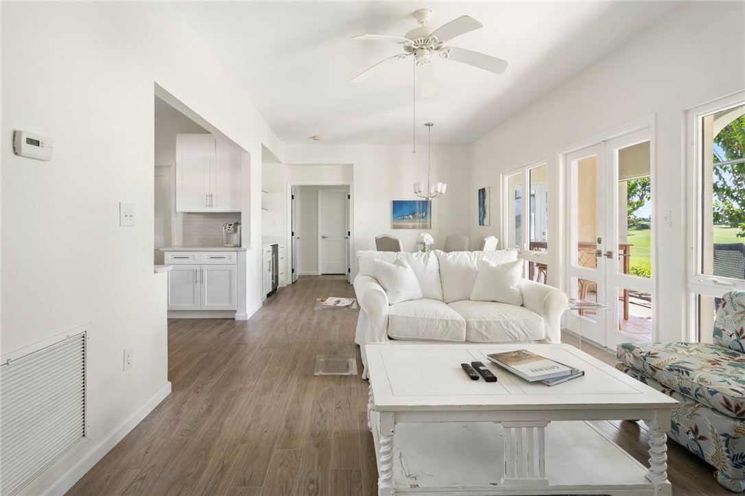 5045 Harmony Circle, Unit 102 Vero Beach, FL 32967 - Photo 13 of 28 a living room with furniture and a wooden floor