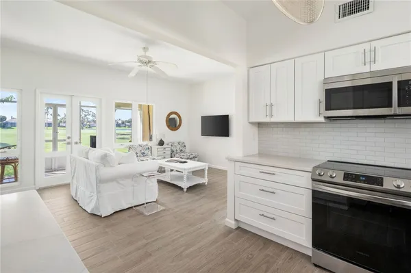 a living room with furniture flat screen tv and view
