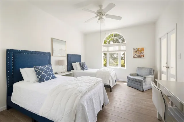 a bedroom with two beds and a chandelier