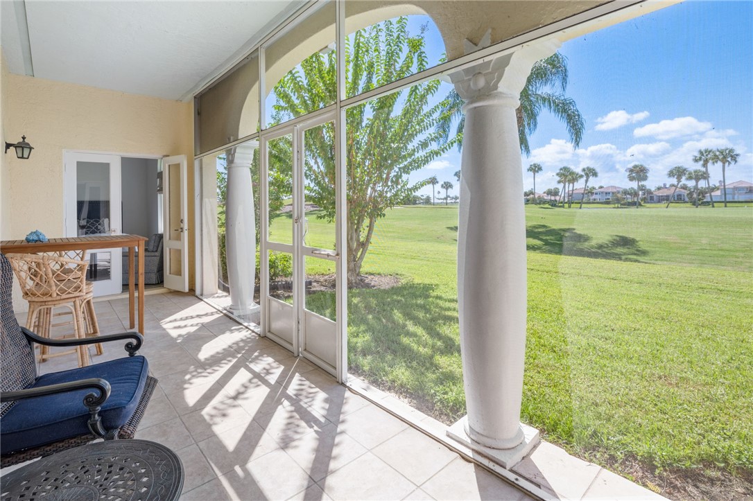 5045 Harmony Circle, Unit 102 Vero Beach, FL 32967 - Photo 2 of 28 a bedroom with furniture and a large window