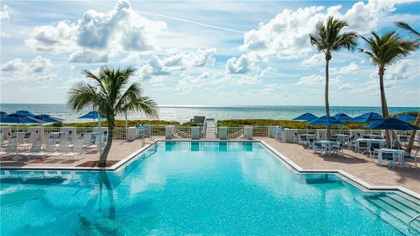 a view of a swimming pool with a lawn chairs
