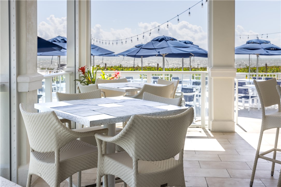 5045 Harmony Circle, Unit 102 Vero Beach, FL 32967 - Photo 25 of 28 a view of a patio with a table and chairs