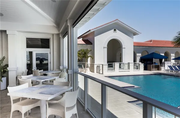 a view of a kitchen with a dining table chairs and white cabinets