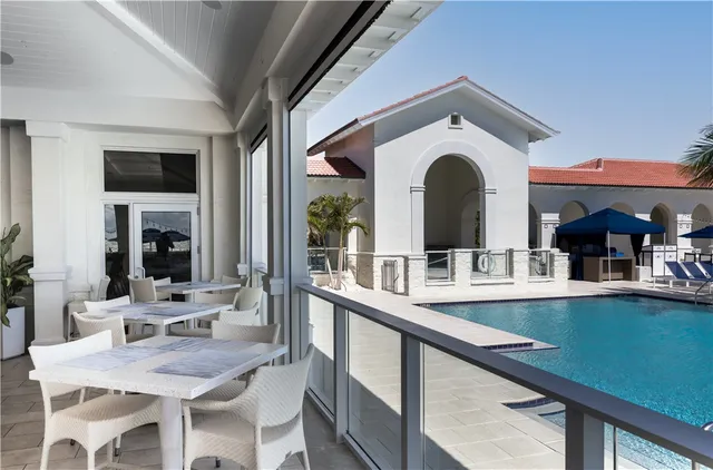 a view of a kitchen with a dining table chairs and white cabinets