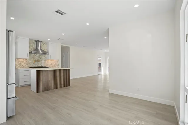 a view of kitchen with kitchen island and wooden floor