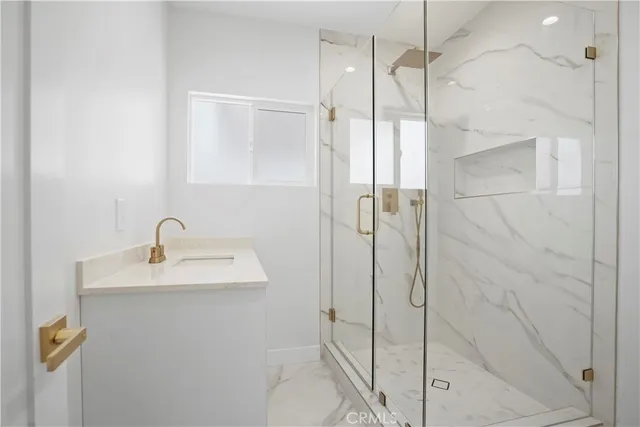 a bathroom with a shower and a sink