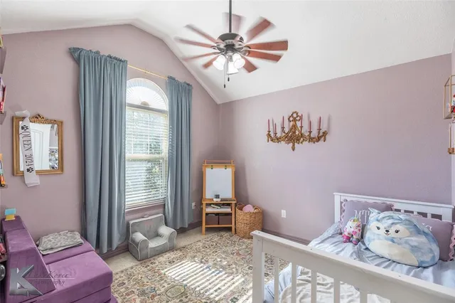 a living room with furniture and a bookshelf