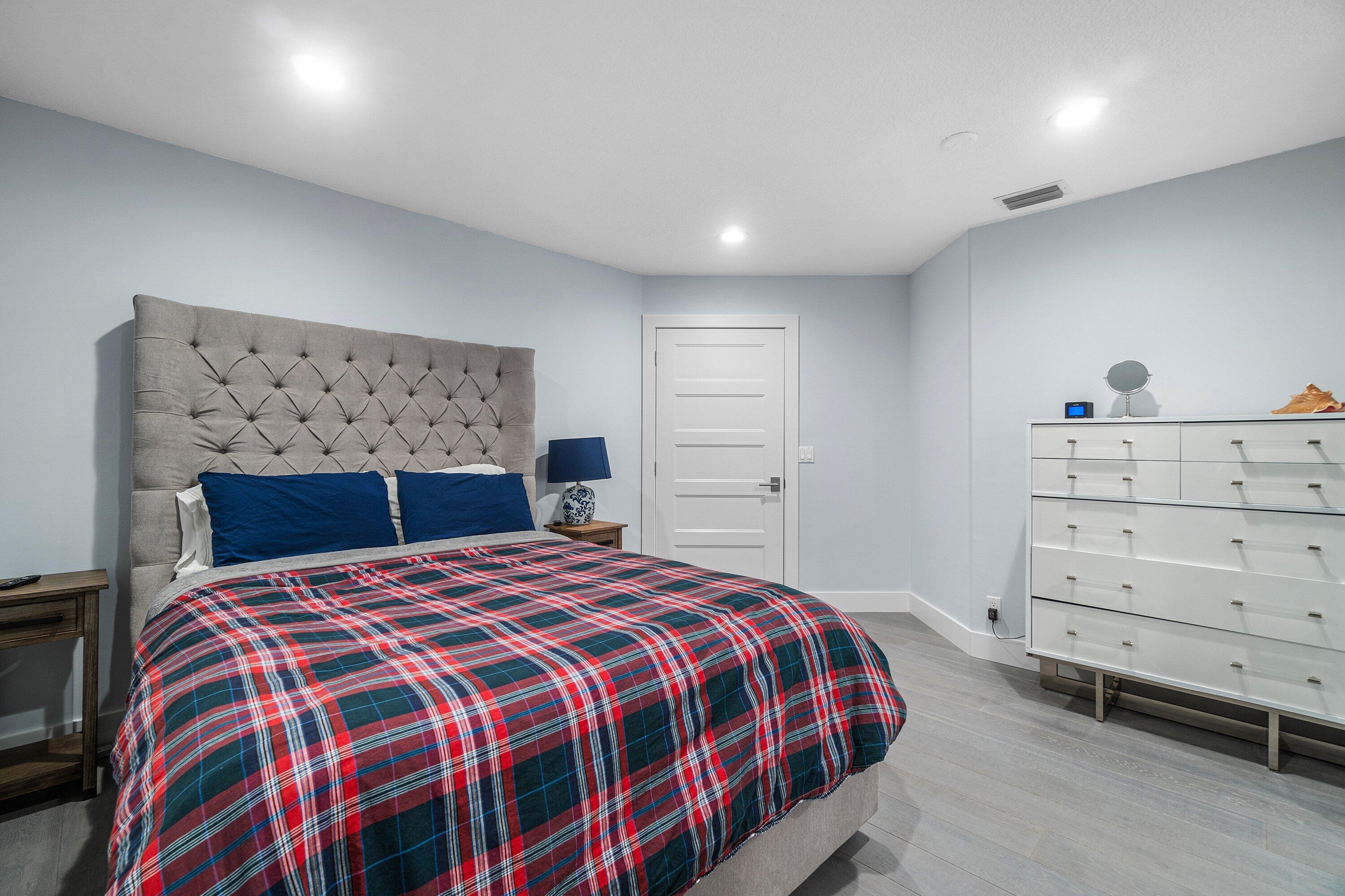 2404 Northwest 67th Street Boca Raton, FL 33496 - Photo 33 of 74 a bedroom with a large bed and a dresser