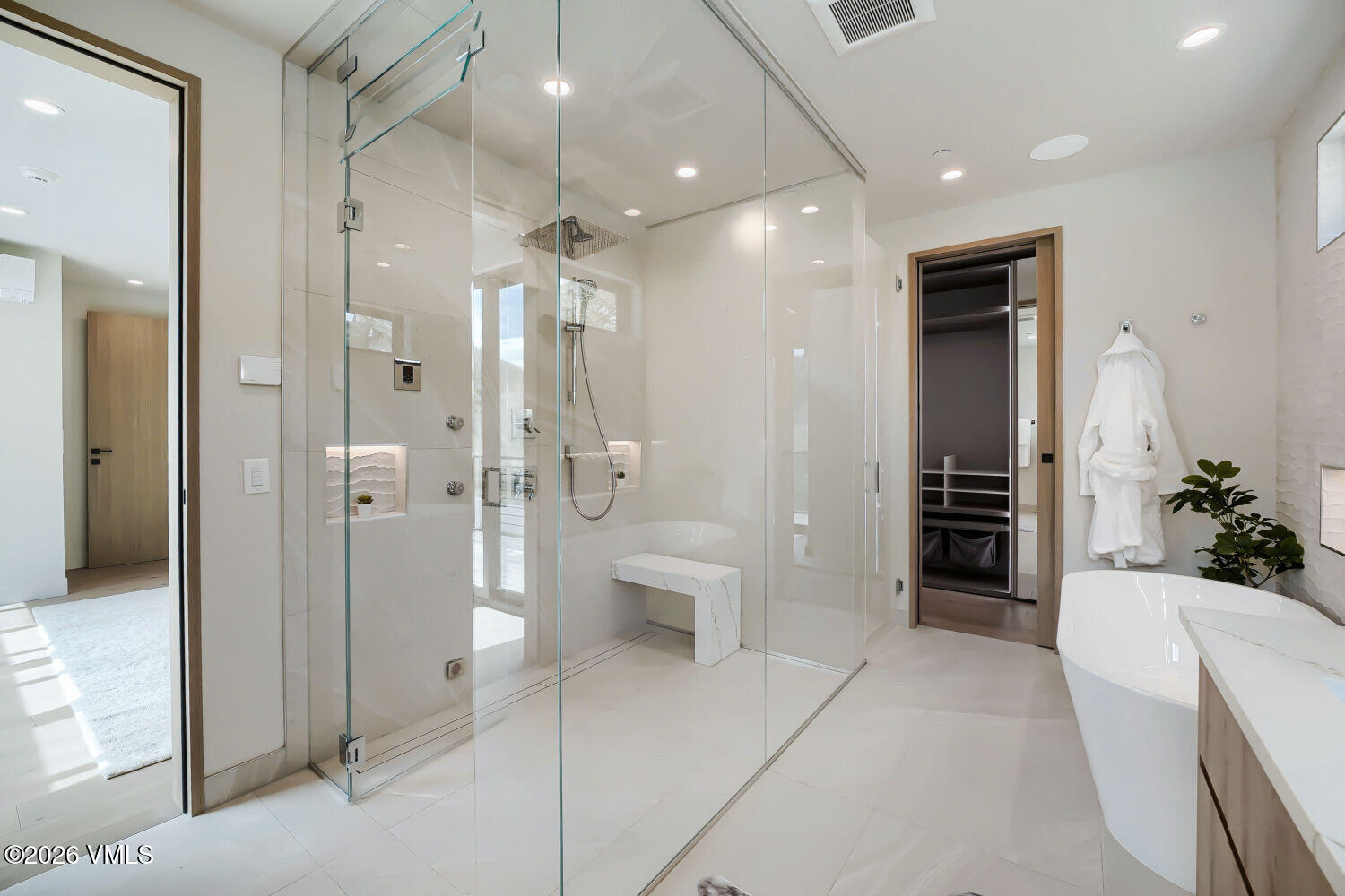 2811 Bald Mountain Road Vail, CO 81657 - Photo 32 of 59 a bathroom with a glass door shower a sink and a mirror