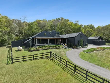 a front view of house with a garden