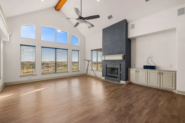 a large kitchen with stainless steel appliances granite countertop a lot of counter space and a sink