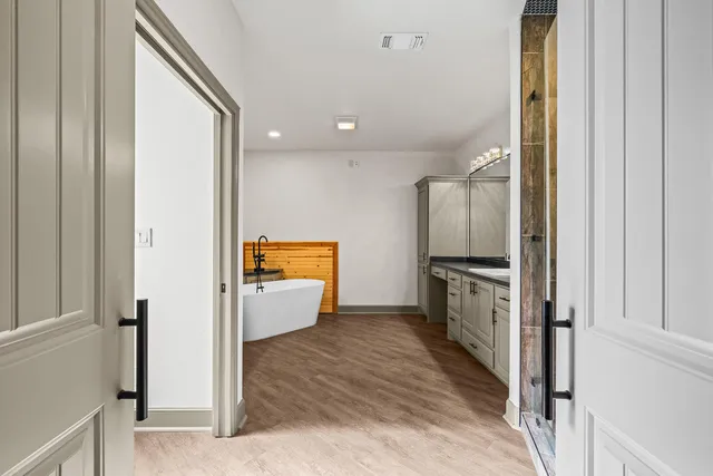 a view of entryway and hall with wooden floor