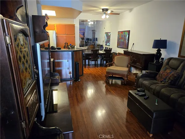 a living room with lots of furniture and a floor to ceiling window