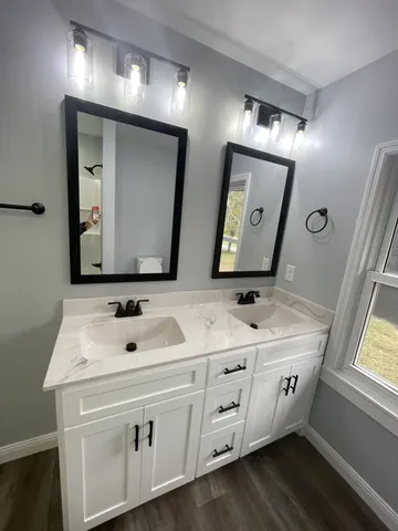 a bathroom with a double vanity sink and mirror