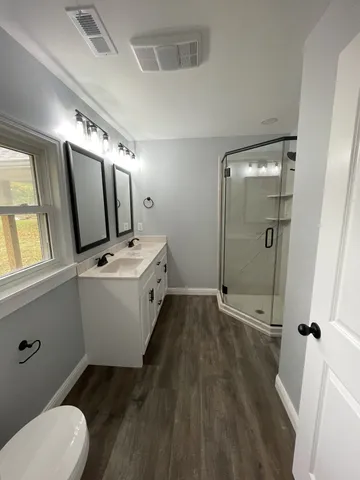 a bathroom with a sink toilet and shower